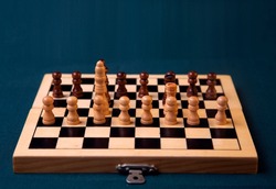 A Chess Pieces on a board with brown and Cream Colored Pawns on a blue background