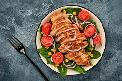 Chicken fillet with salad spinach, cherry tomatoes, cornflower and onion. Healthy food. Keto diet, diet lunch concept. Top view on white background.