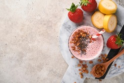 Strawberry smoothie. Vegan smoothie or milkshake from strawberry, banana and mint on white wooden table background. Clean eating, alkaline diet. Top view. Mock up.