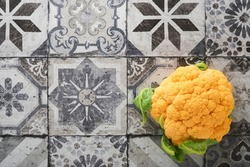 Colorfu cauliflower. Various sort of cauliflower on stone tiles gray concrete background. Purple, yellow, white and green color cabbages. Broccoli and Romanesco. Agricultural harvest. Mock up.