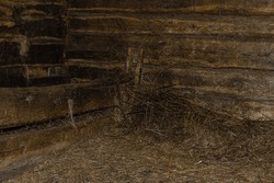 The interior of the old rustic stable. Place for animals where they are feeding and resting. Inside old wooden stable. Empty wooden room