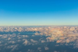 The boundaries of the Earth's atmosphere between the troposphere and the stratosphere show clouds that are at the top of the troposphere and the blue sky.