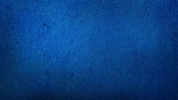 grunge dark blue gradient stucco wall background. abstract grainy blue wall background with space for text.