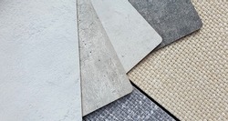 various texture and color of cement or concrete laminated samples isolated on beige and grey sackcloth fabric background with clipping path. interior material combination background for rustic mood.