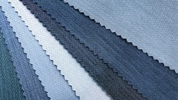 samples of fabric for interior upholstery or drapery works in blue color tone. swatch of blue zigzag pattern fabric. fabric for luxury interior style. close-up image.