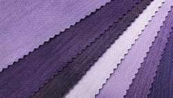 samples of fabric for interior upholstery or drapery works in purple tone color. swatch of violet zigzag pattern fabric. fabric for luxury interior style. close-up image.