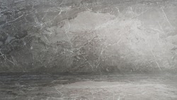abstract grey marble texture in perspective view. empty room of luxury emperado marble finishing, wall and floor, with artificial light. indoor for products displayed (focus at center of image).