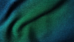 close up texture of creased fabric. gradient in green and blue color tone, woolen fabric. wavy cloth background showing fiber detail. gradient drapery background with beautiful, light and shadow.