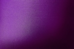 luxury dark purple leather texture background showing grain and a shaft of light across. gradient violet artificial leatherette texture use as background, close up view, with blank space for design.