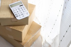 Calculator and cardboard, luggage cost image