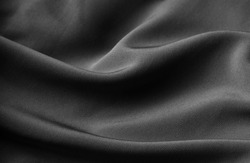 Beautiful luxury shadow black cloth background, Beautiful elegant black background with drapery and wavy folds of silk satin material texture. Top view. Velvet Cloth. Black webiste banner. 