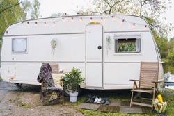 Family traveling in camper,house on wheels,trailer,motor home. Romantic road travel,freedom life.Campsite overnight, parking in van.Wanderlust vacation,weekend. Happy adventure.Relax area with chairs.