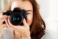 Photographer woman girl is holding dslr camera taking photographs