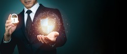 Businessman holding shield protect icon for internet firewall, insurance, or computer virus cleaner. Concept cyber security safe your data.