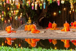 Monks prayer on Buddhas day under Banyan tree in Wat Phan tao temple Chiang Mai.