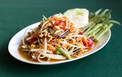 Papaya Salad Thai style (Som tum ) serve with fresh grees vegetable