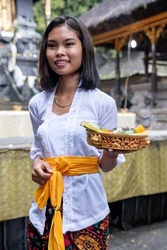 Local Girl in a Balinese temple carrying offerings, Kintamani, Bali 