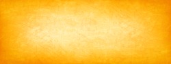 Abstract yellow brown orange background. Toned cement rough plaster wall texture. Bright wide banner. Panorama. Autumn, Thanksgiving, Halloween concept background. Copy space.