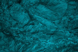    Blue green grunge background. Toned rock texture background. Combination of teal color and rough cracked stone surface. Tidewater Green color abstract background.                            
