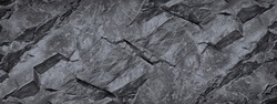 Rock texture. The surface of the mountain is like a stone wall. White gray grunge background with copy space for design. Wide banner. Panoramic. Volumetric 3D effect.