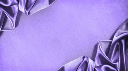 Beautiful purple pink silk satin background. Soft folds. Shiny fabric. Luxury lilac background with copy space for design. Web banner. Flat lay, top view. Birthday, wedding, Christmas, Valentine.