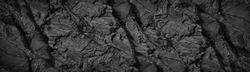 Black white rock texture background. Rough mountain surface with cracks. Close-up. Dark gray stone basalt background for design. Banner. Wide. Long. Panoramic. Website header.