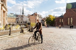Young man riding a bike. Sustainable mobility transport New way of inclusive cities mobility. Green transportation. Sustainable climate neutral city goals. Green mobility and transportation
