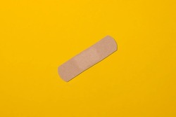 beige plaster on yellow background, vaccination concept