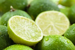 Backgrounds. Close up shot of wet  limes. Focus on the central part of sliced lime.