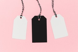 Black and white empty tags on pink background. Mockup price tag. Sale and Black Friday concept