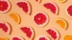 Citrus fruits banner with harsh shadows, slices of grapefruit and orange