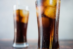 close up glasses with cola and ice, refreshing drink.
