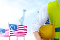 Construction worker holding hardhat. Happy Labor Day
