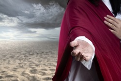Jesus Christ with open palm giving helping hand with dramatic sky background