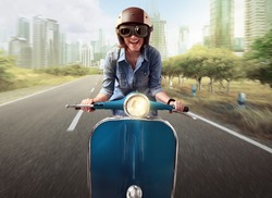 Asian women riding a blue scooter along a city street