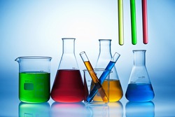 Colorful of liquid in chemistry lab equipment glass on blue background, Chemical laboratory and Science experiment concept