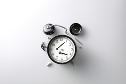 broken black alarm clock on grey background with copy space , time and wilted concept