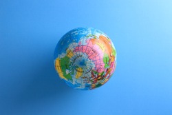 world globe ball on blue paper background 