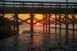 Watching sunrise through the ocean pier
