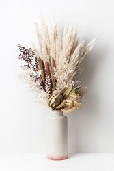 Stylish modern dried flower arrangement in a cream and pink vase. Including Banksia, pampas grass, bulrush and ruscus leaves. Art decoBoho gift for Anniversary, birthday, mothers day.