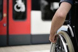 Person wheelchair user at station at barrier free accessibility compartment  sign mobility transport