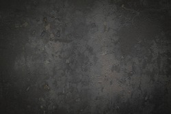 Gray or black concrete background with rough texture and dirt.