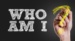 Hand writing the text: Who Am I?