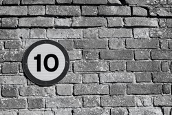 10 miles an hour traffic sign on an old brick background
