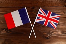 Flag of France and flag of Great Britain crossed with each other. The image illustrates the relationship between countries. Photography for video news on TV and articles on the Internet and media.