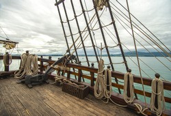 old sailing ship with strings and a mast or wooden ship or principal deck of a sailing ship