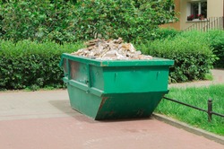 Container with solid household and construction waste. Waste recycling. Caring for the environment