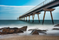 Landscape photography with an old industrial bridge that juts out into the sea
