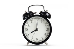 Classic black table clock isolated on a white background. Alarm clock show 8 O'Clock with copy space.