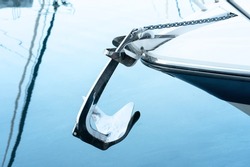 Bow anchor in polished stainless steel protruding from the bow of the boat